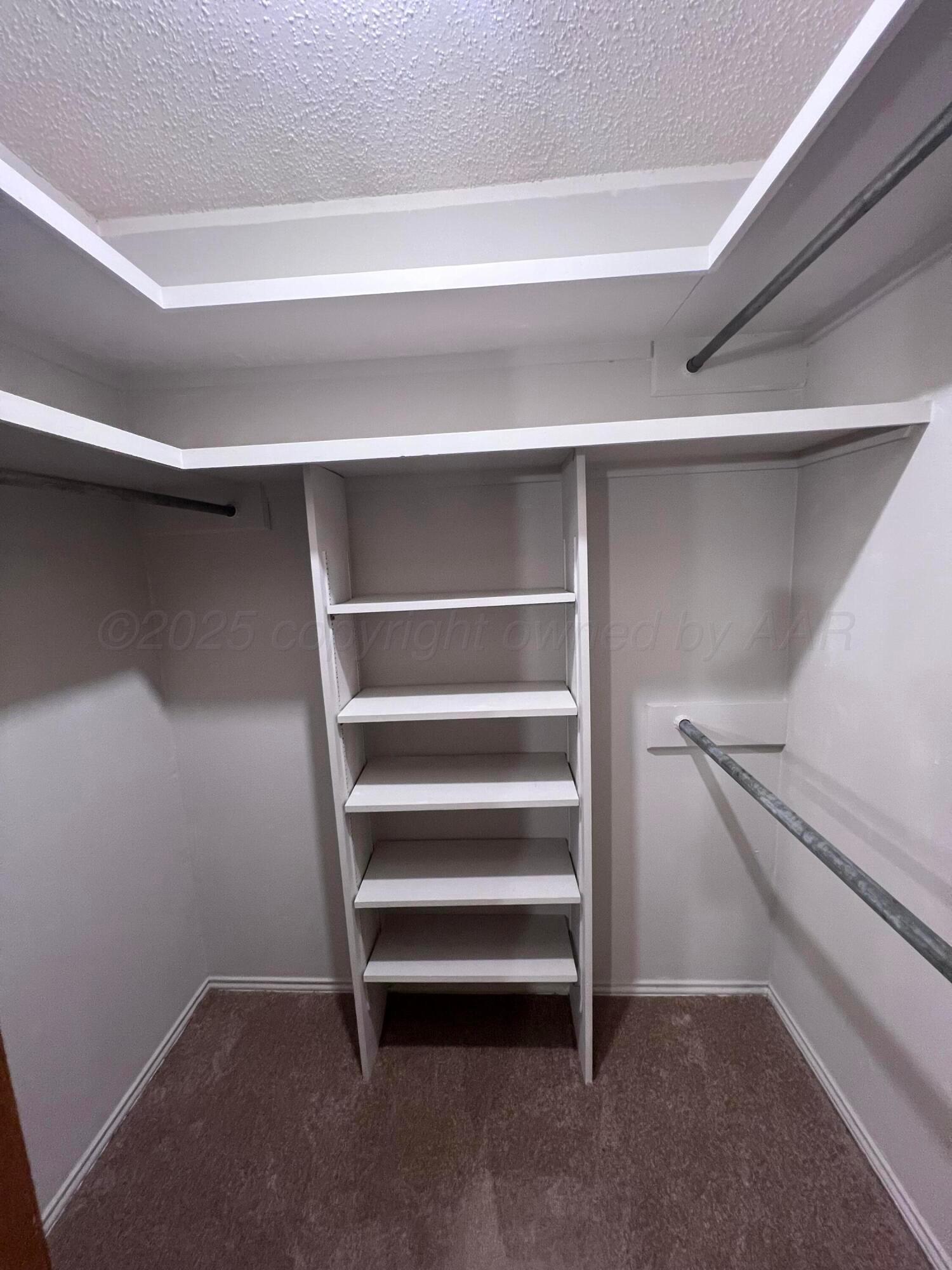 807 North Arrah Friona, TX 79035 - Photo 25 of 56 a view of walk in closet with empty racks