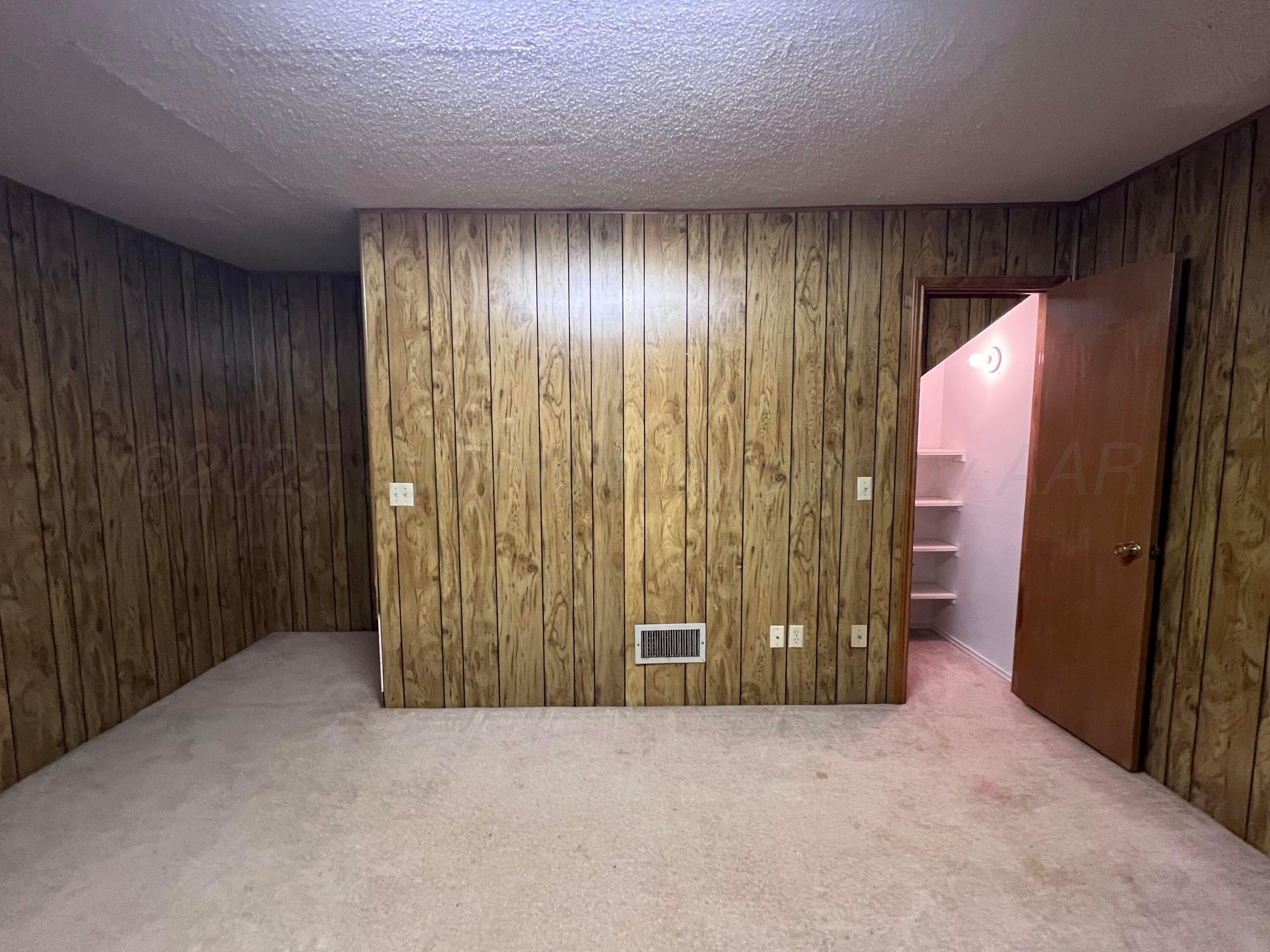 807 North Arrah Friona, TX 79035 - Photo 40 of 56 wooden floor in an empty room with a window