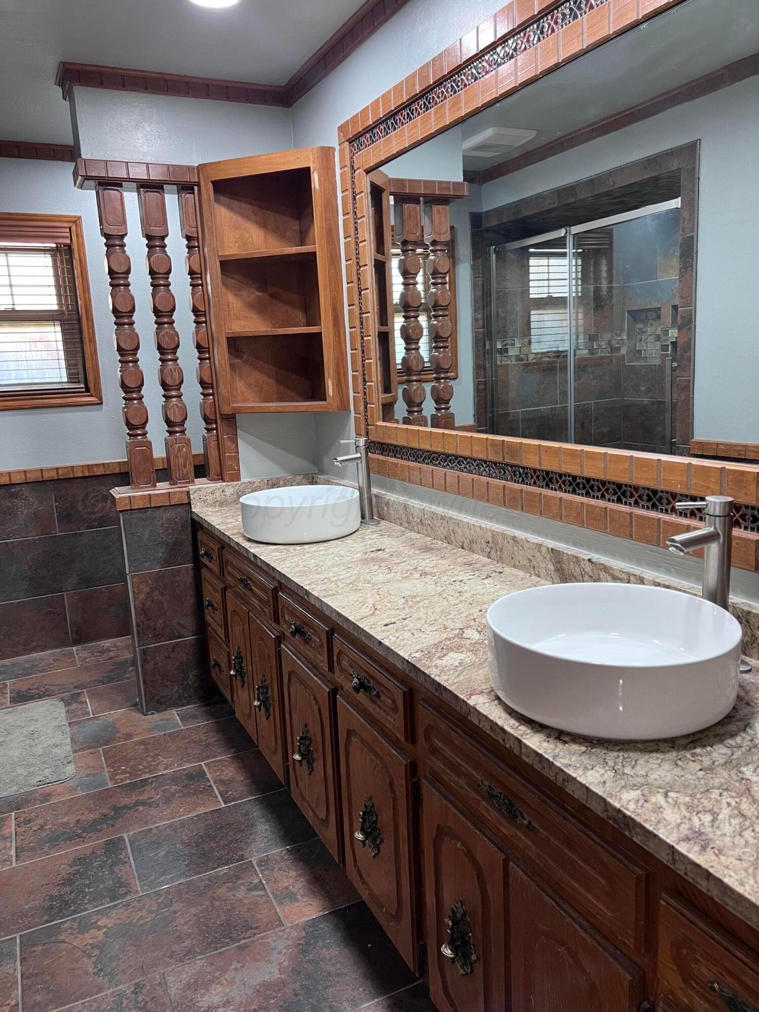 807 North Arrah Friona, TX 79035 - Photo 49 of 56 a bathroom with a granite countertop sink and a large mirror