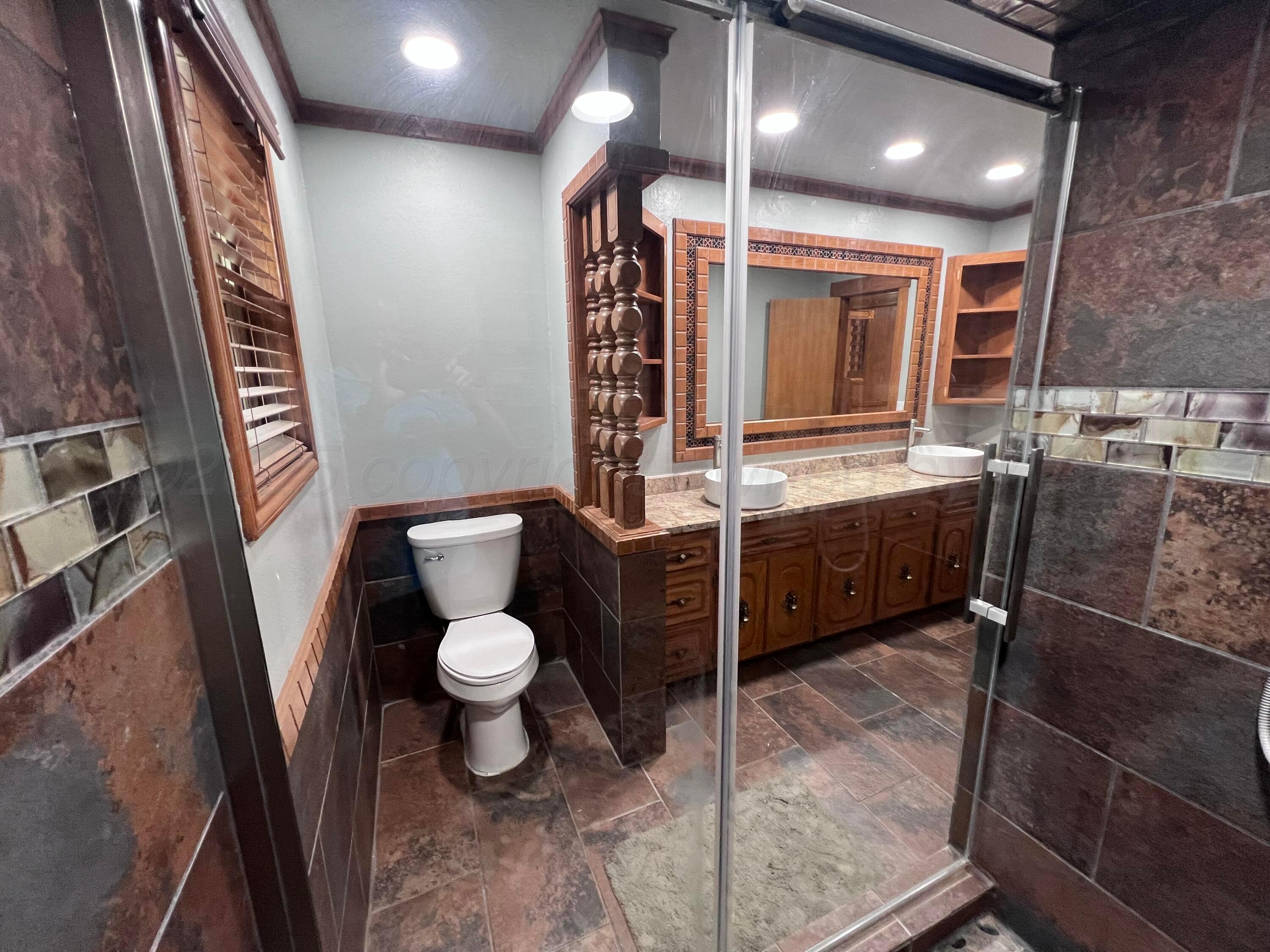 807 North Arrah Friona, TX 79035 - Photo 51 of 56 a bathroom with a toilet a sink and mirror