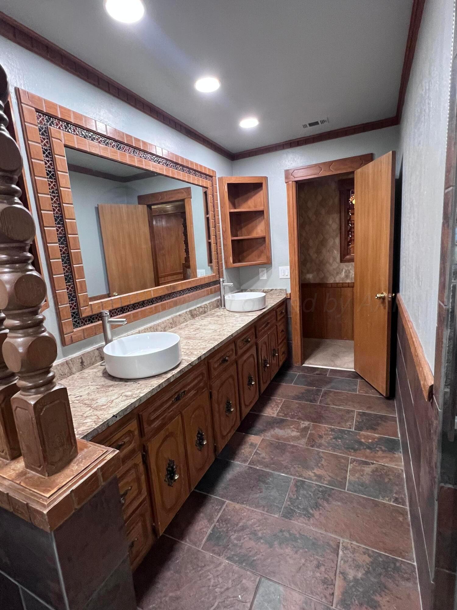 807 North Arrah Friona, TX 79035 - Photo 52 of 56 a bathroom with a granite countertop sink and a mirror
