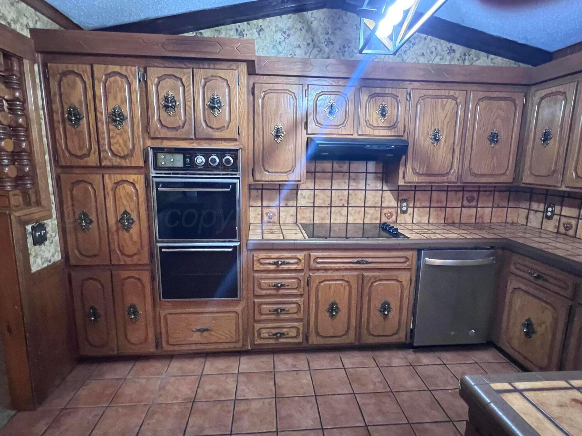 807 North Arrah Friona, TX 79035 - Photo 10 of 56 a kitchen with stainless steel appliances granite countertop a stove and a cabinets