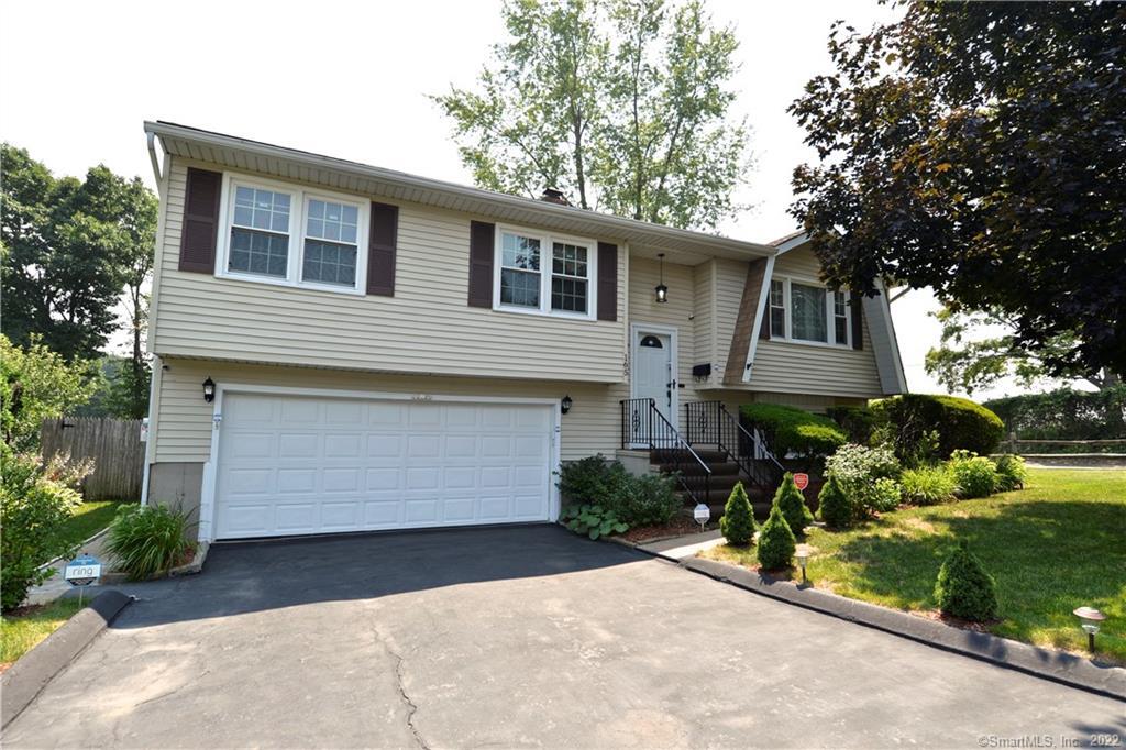 a front view of house with garage and yard