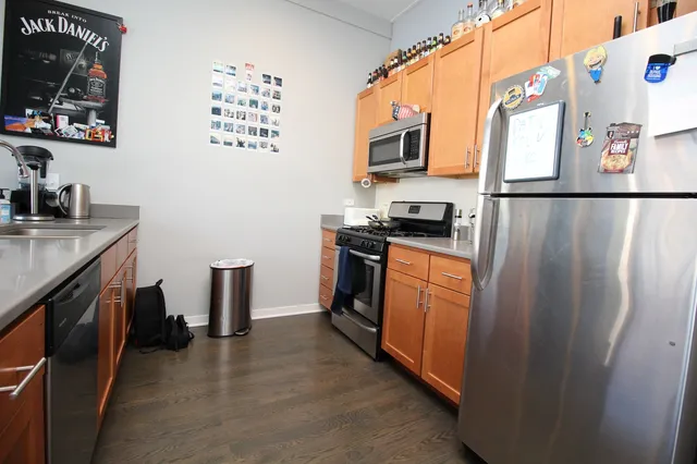 a kitchen with stainless steel appliances granite countertop a sink and a microwave