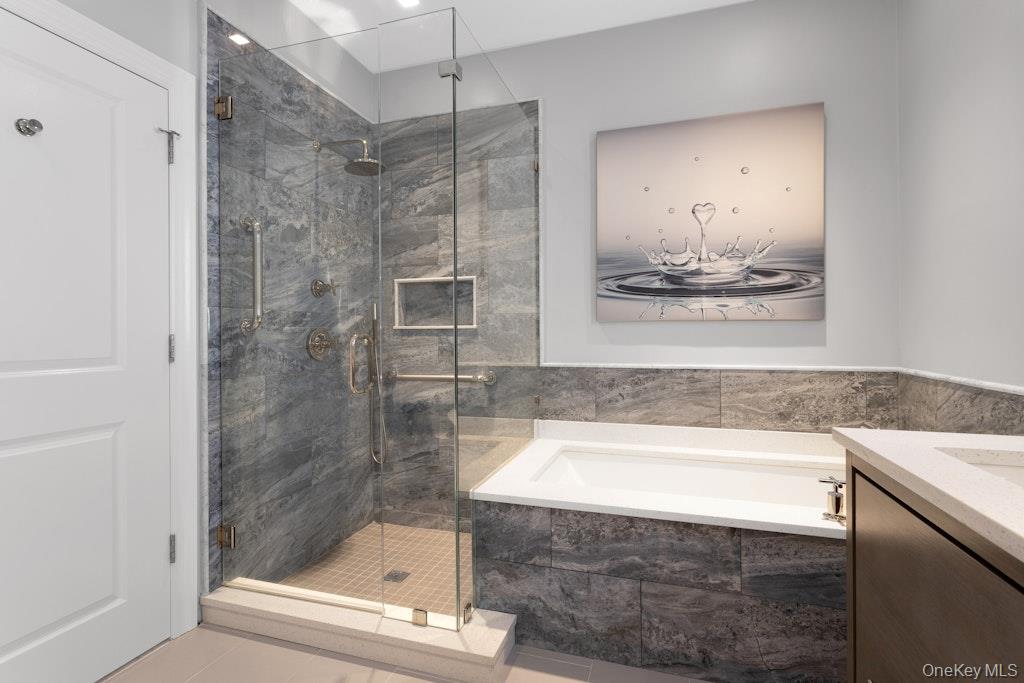 18 Rivers Edge Drive, Unit 211 Tarrytown, NY 10591 - Photo 15 of 30 a bathroom with a bathtub and a shower