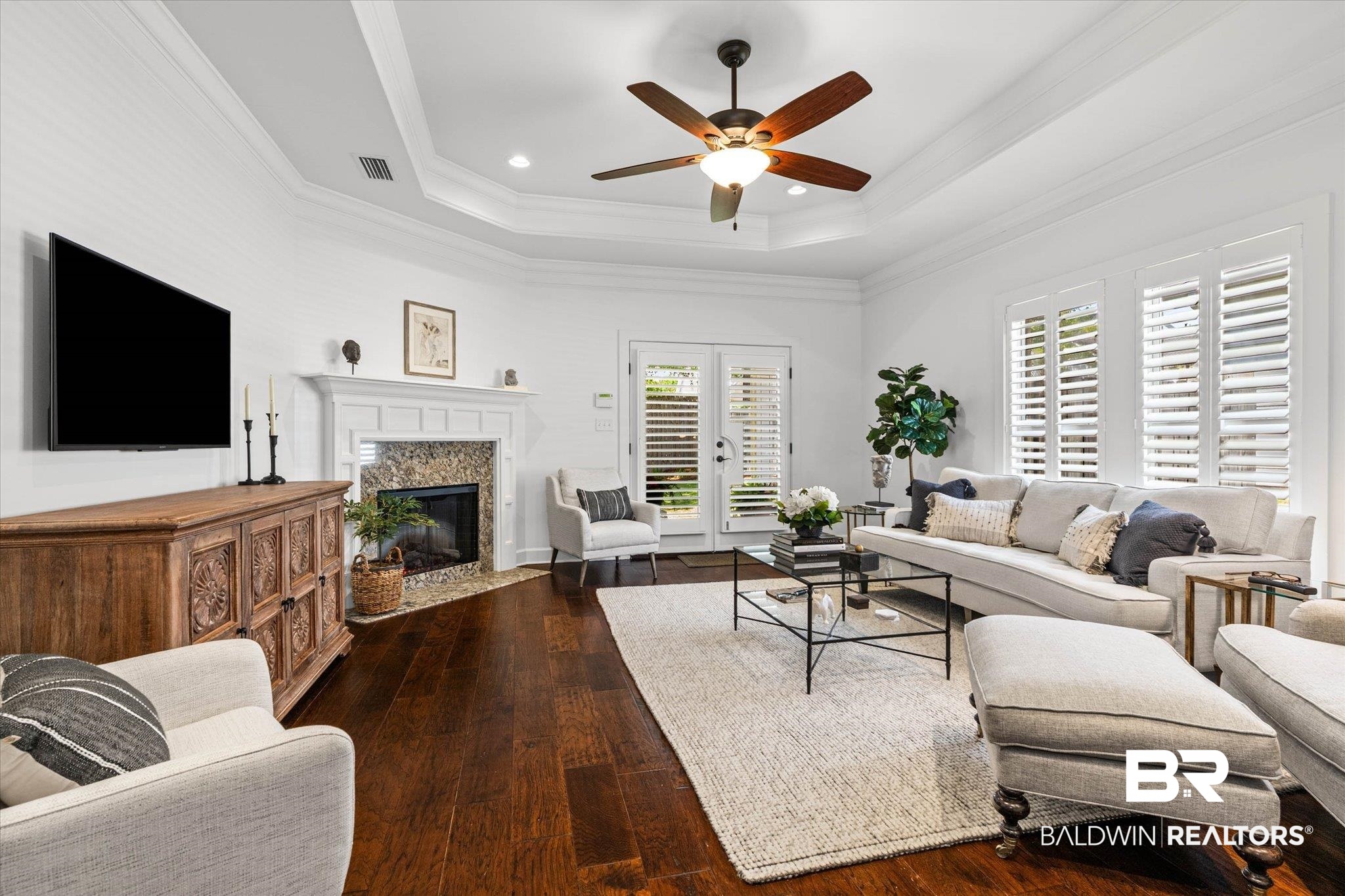 1052 Linlen Avenue Mobile, AL 36609 - Photo 8 of 22 Living room featuring dark wood-type flooring, a fireplace, a ceiling fan, crown molding, and recessed lighting