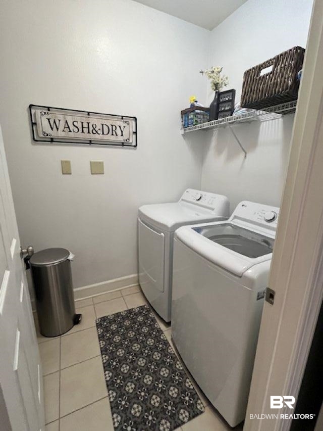 450 Park Avenue, Unit 112 Foley, AL 36535 - Photo 14 of 20 Laundry room with washer and dryer, light tile patterned floors, and baseboards