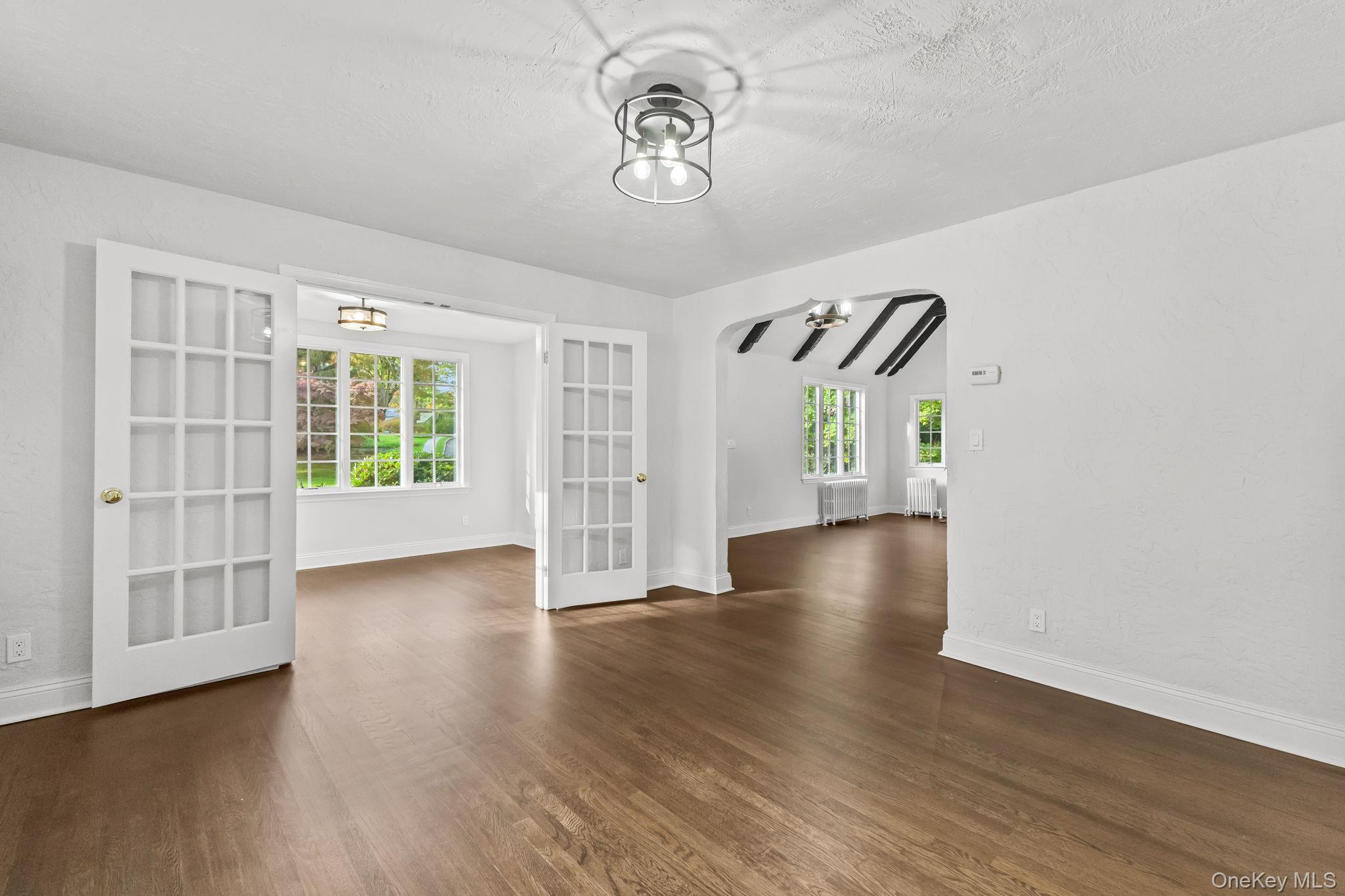 202 East Garden Road Larchmont, NY 10538 - Photo 15 of 35 a view of an empty room with window and wooden floor