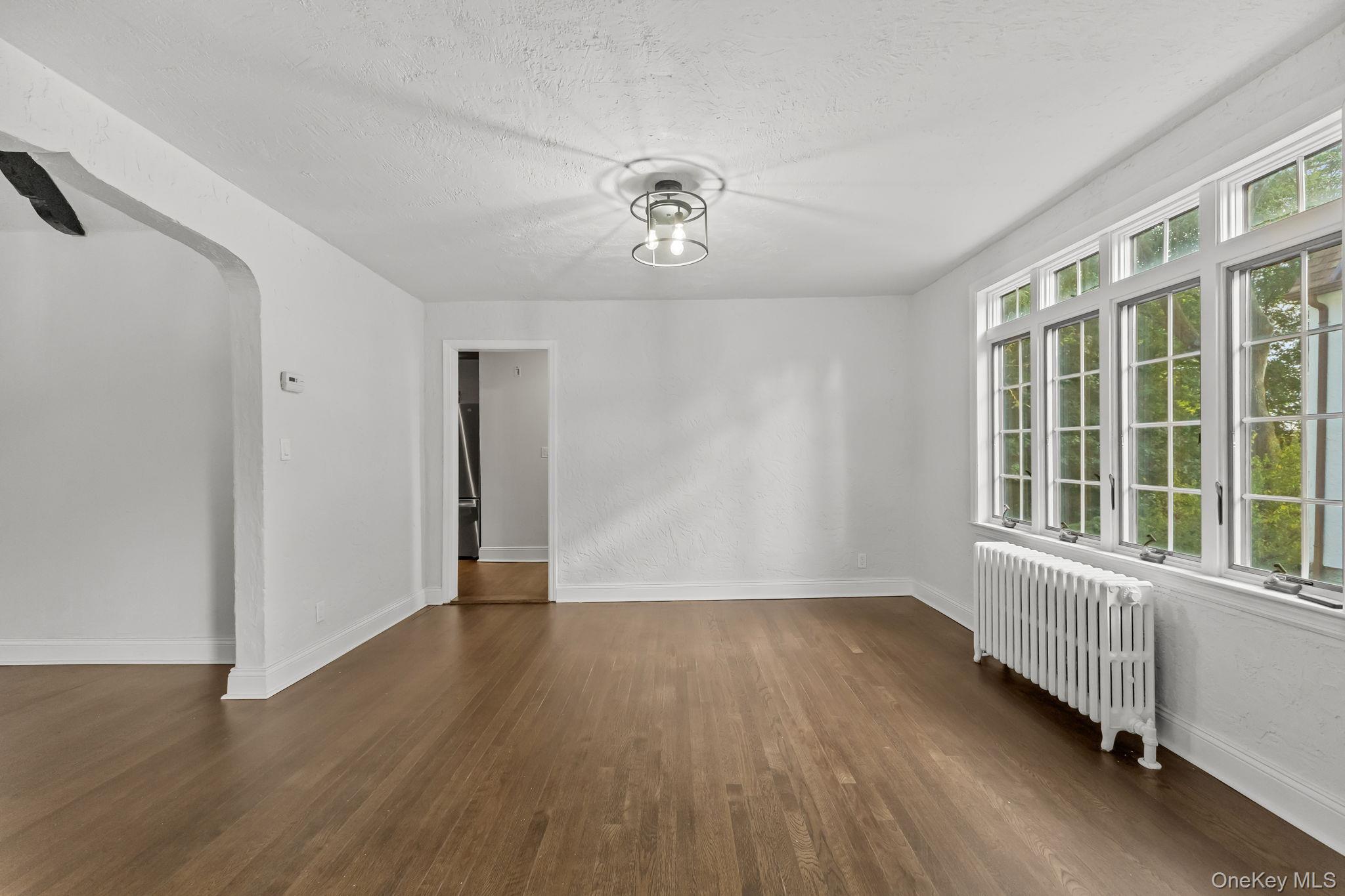 202 East Garden Road Larchmont, NY 10538 - Photo 16 of 35 a view of an empty room with wooden floor and a window