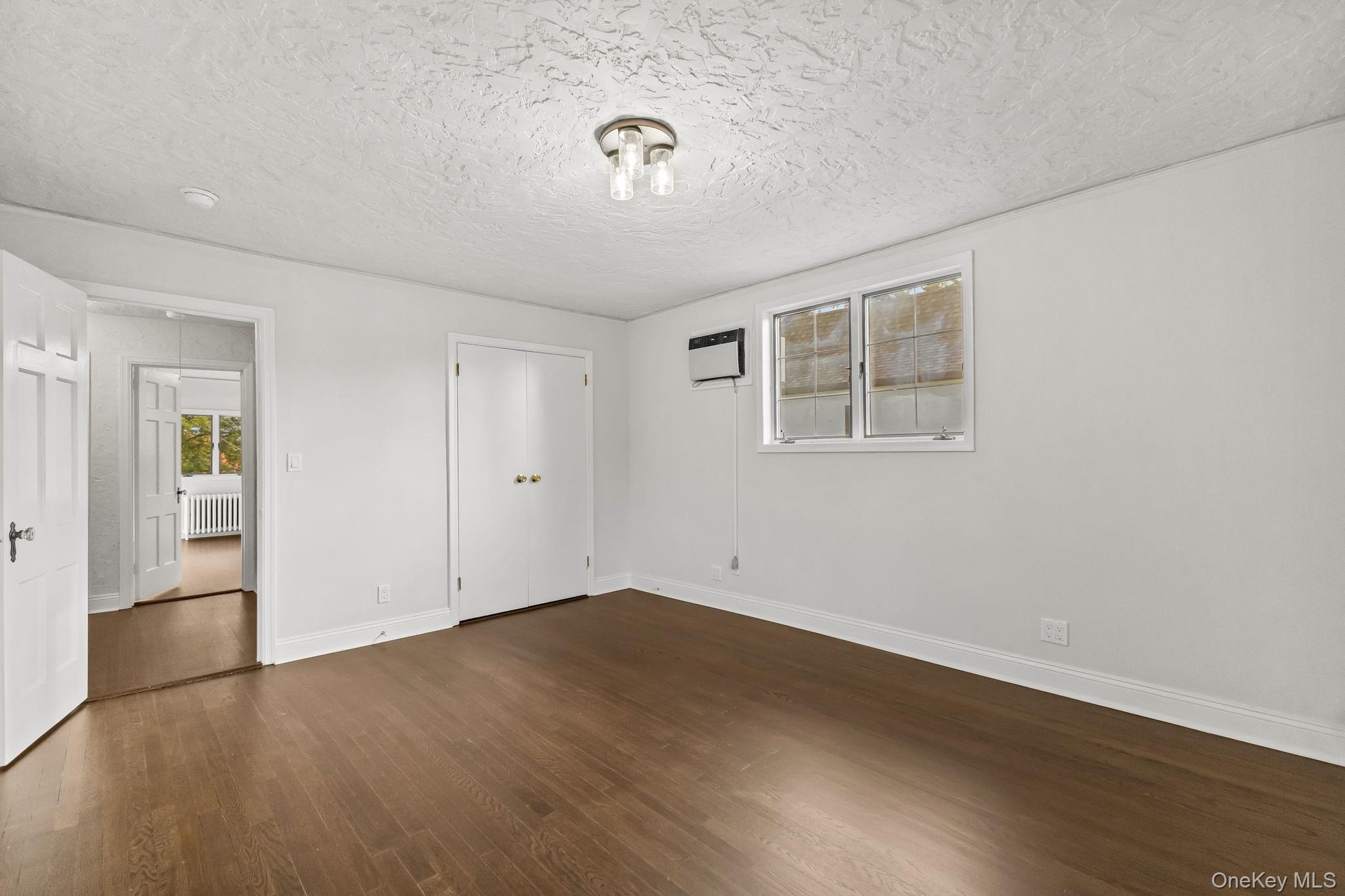 202 East Garden Road Larchmont, NY 10538 - Photo 22 of 35 an empty room with wooden floor and windows