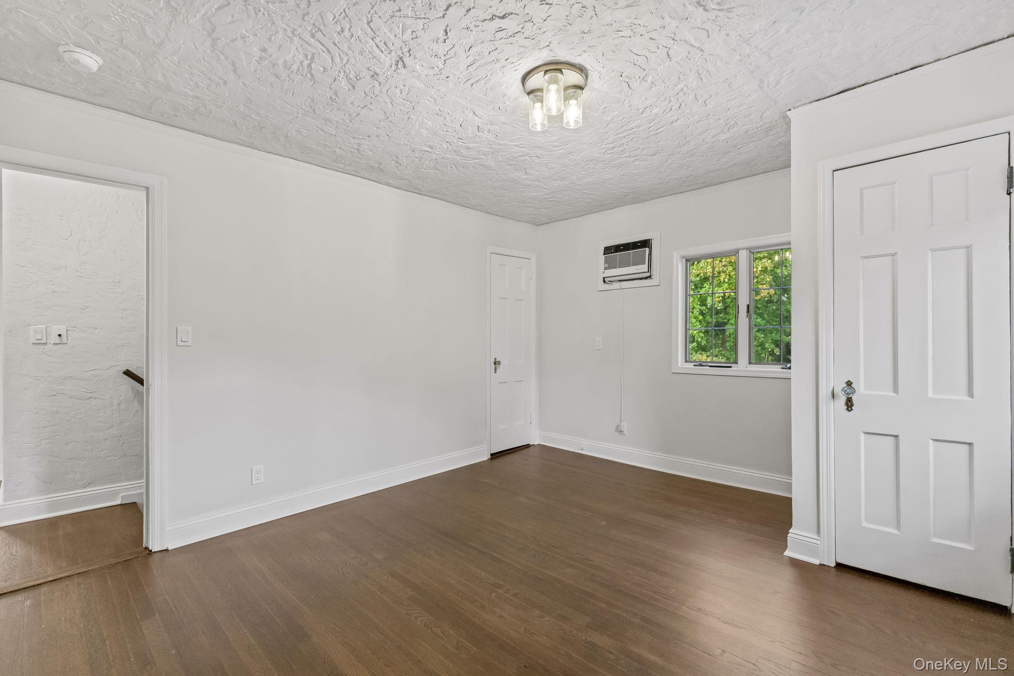202 East Garden Road Larchmont, NY 10538 - Photo 24 of 35 an empty room with wooden floor and windows