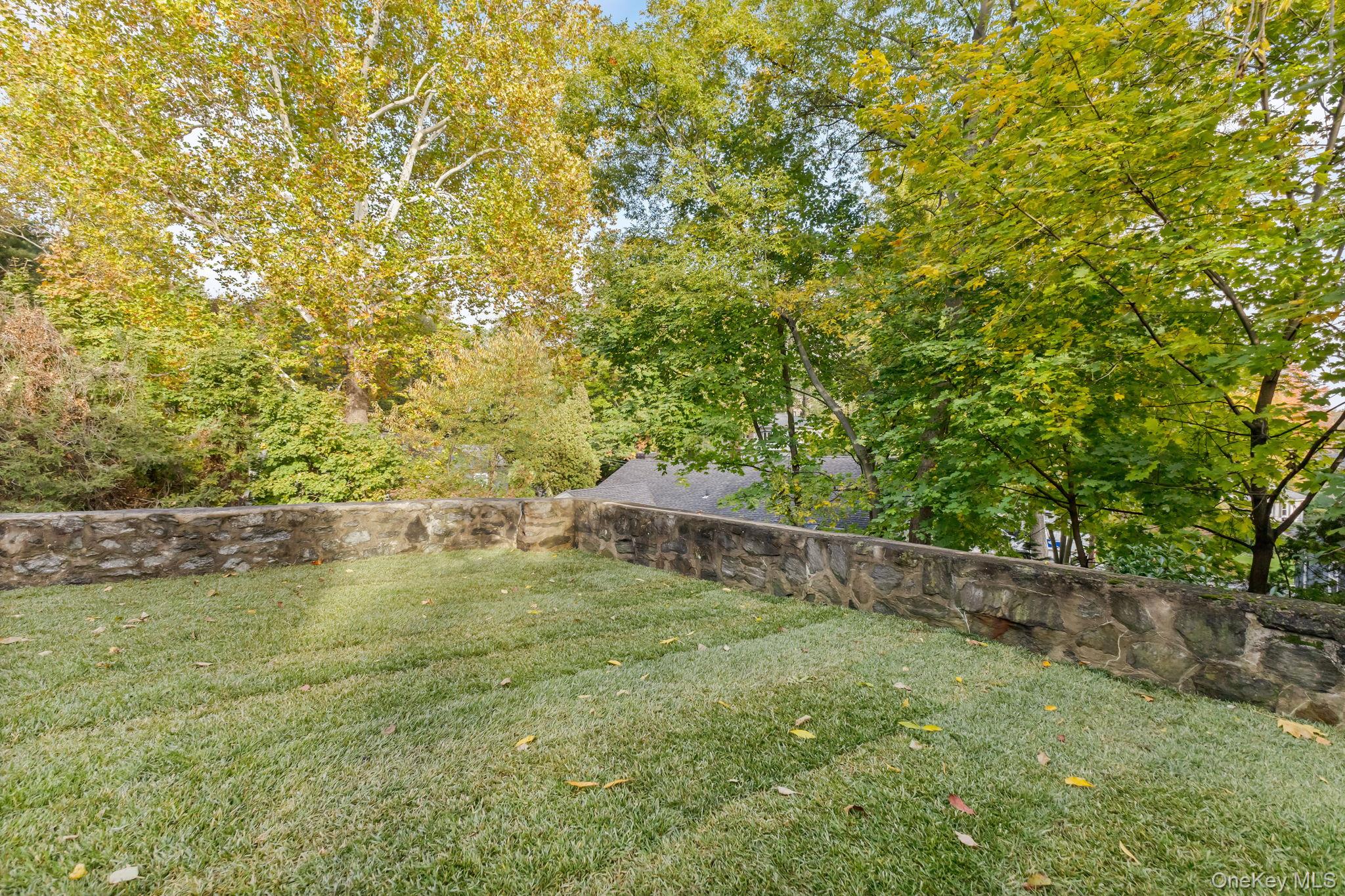 202 East Garden Road Larchmont, NY 10538 - Photo 32 of 35 a view of a swimming pool with an outdoor seating and a forest