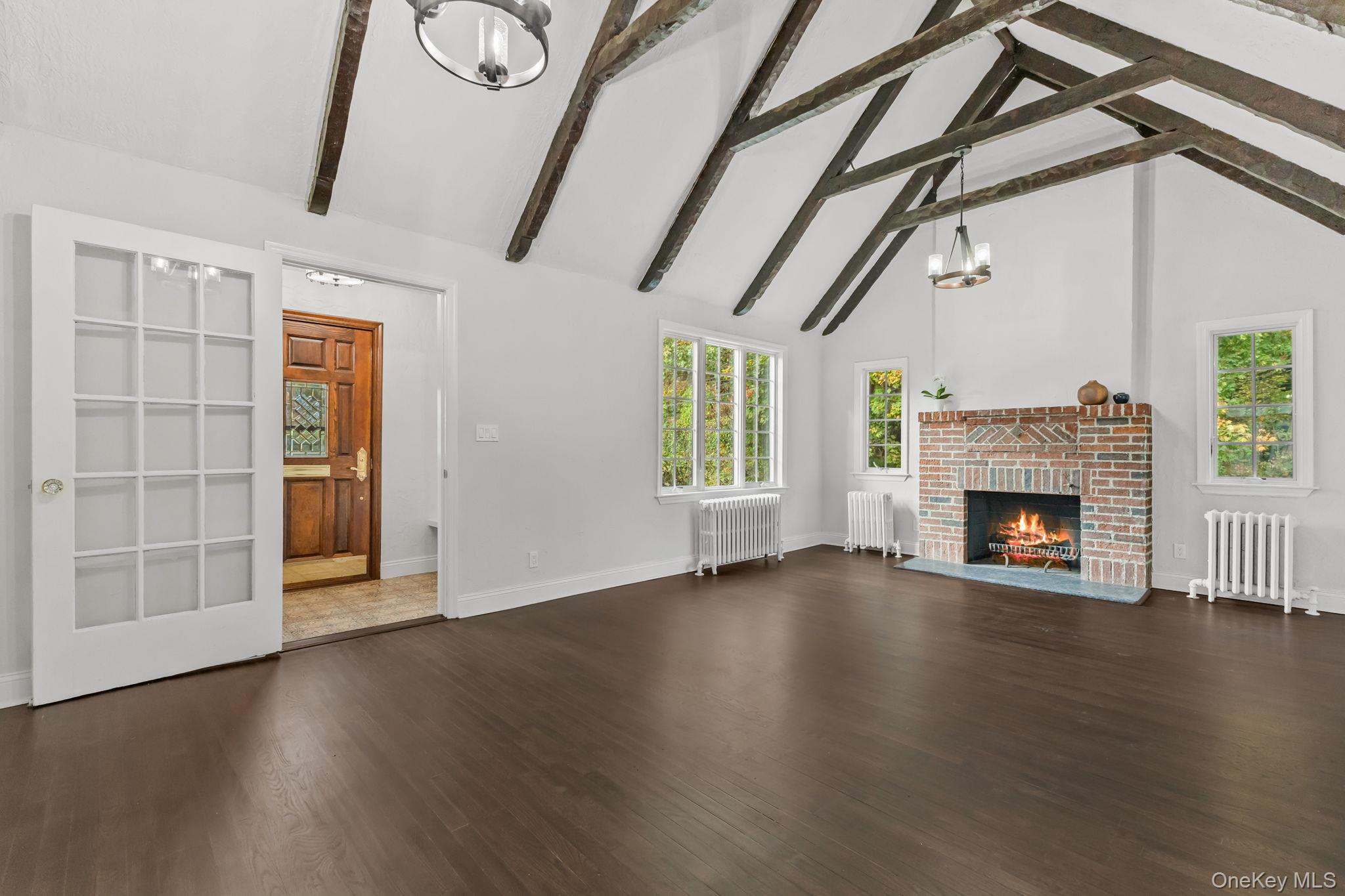 202 East Garden Road Larchmont, NY 10538 - Photo 5 of 35 a view of an empty room with wooden floor fireplace and a window