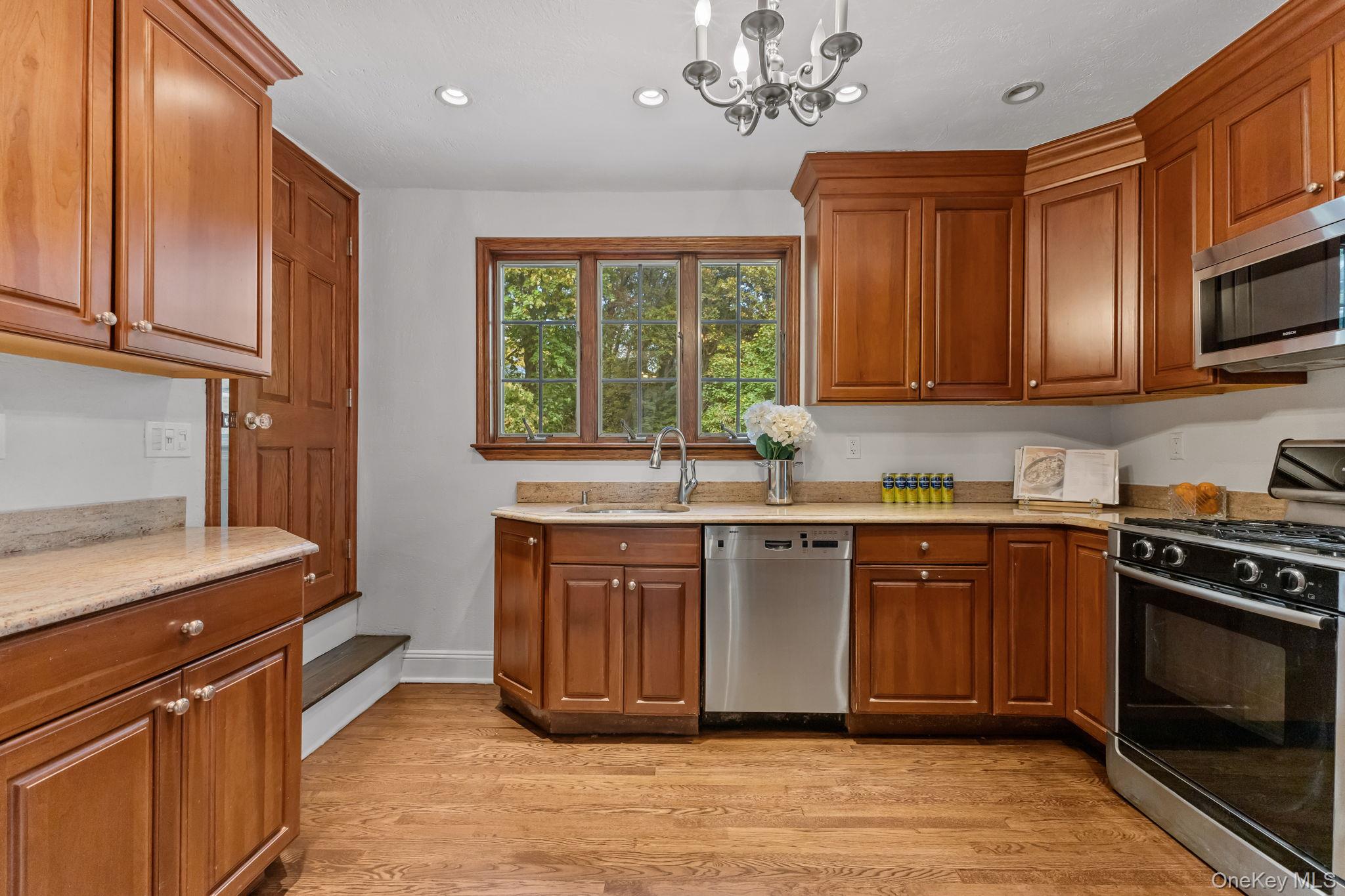 202 East Garden Road Larchmont, NY 10538 - Photo 8 of 35 a kitchen with stainless steel appliances granite countertop a stove a sink and a microwave