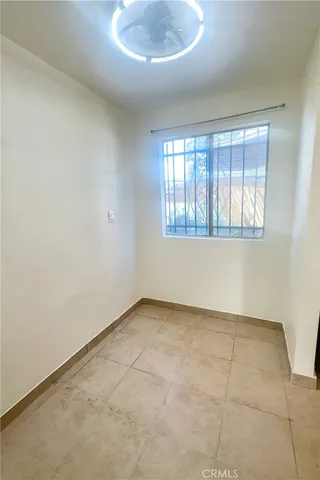 an empty room with white walls and tiles