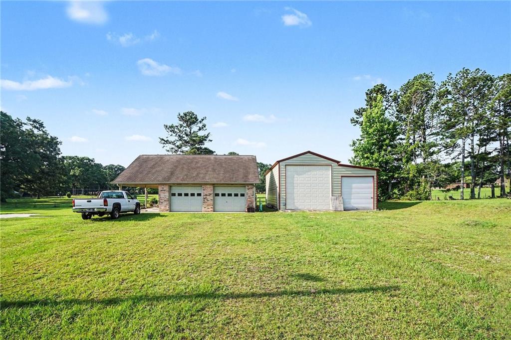 740 Smyrna Road Southwest Conyers, GA 30094 - Photo 25 of 27 a view of a house with a yard and sitting area