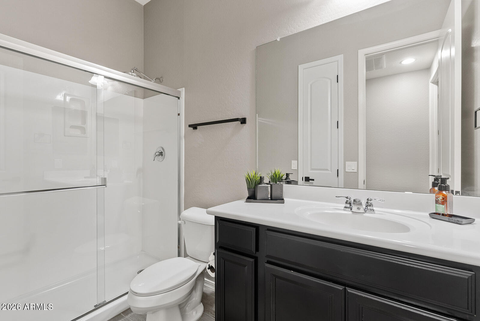 19411 East Timberline Road Queen Creek, AZ 85142 - Photo 12 of 44 a bathroom with a granite countertop sink toilet a mirror a vanity and shower