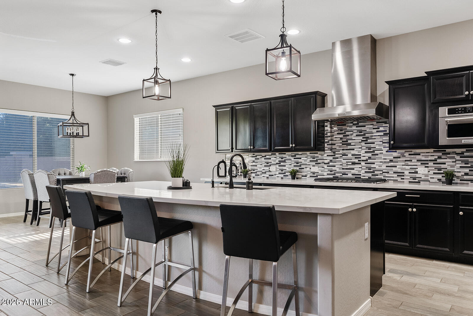 19411 East Timberline Road Queen Creek, AZ 85142 - Photo 15 of 44 a kitchen with stainless steel appliances kitchen island a sink stove and refrigerator