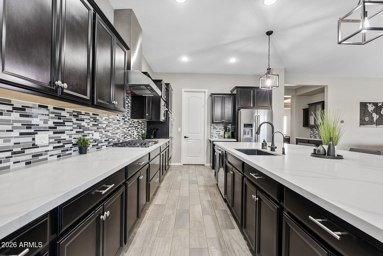 19411 East Timberline Road Queen Creek, AZ 85142 - Photo 18 of 44 a kitchen with stainless steel appliances kitchen island granite countertop a sink a stove and a wooden floors