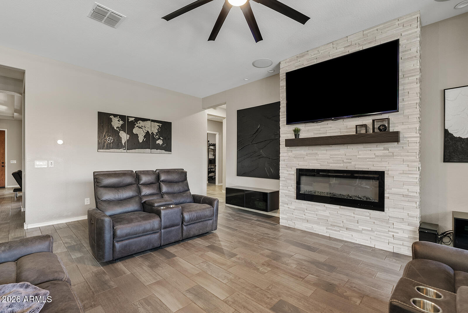 19411 East Timberline Road Queen Creek, AZ 85142 - Photo 22 of 44 a living room with furniture a flat screen tv and a fireplace