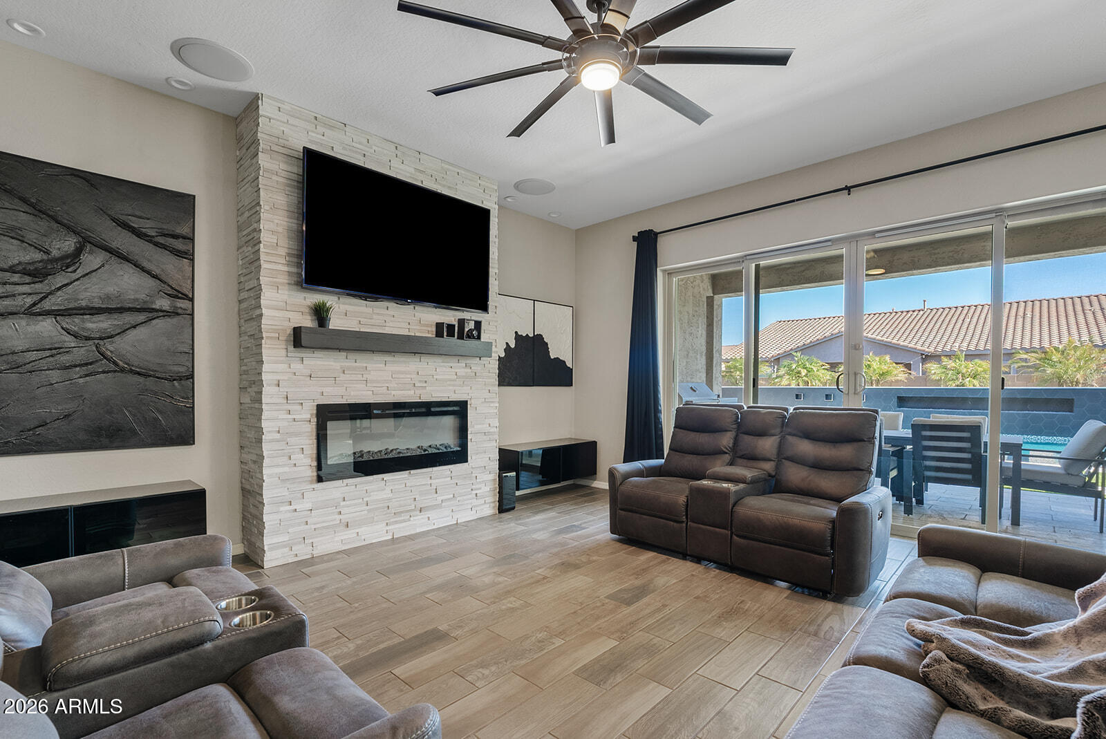 19411 East Timberline Road Queen Creek, AZ 85142 - Photo 23 of 44 a living room with furniture a flat screen tv and a fireplace
