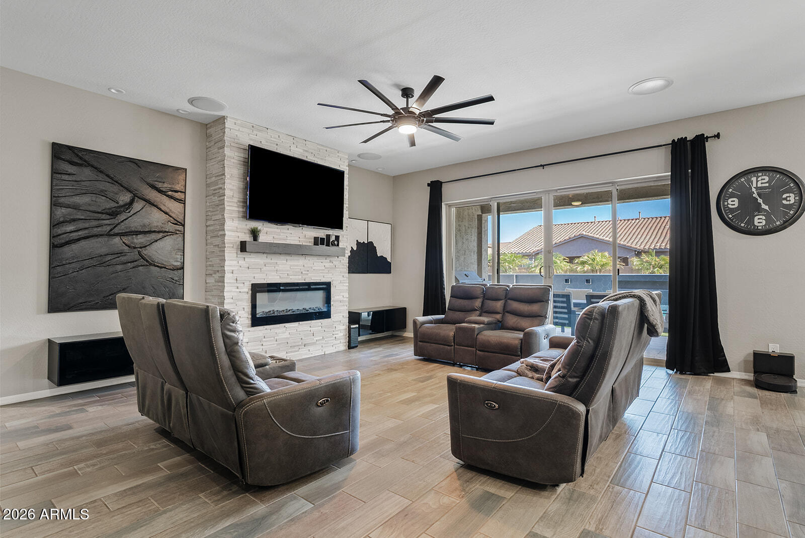 19411 East Timberline Road Queen Creek, AZ 85142 - Photo 24 of 44 a living room with furniture a flat screen tv and a fireplace