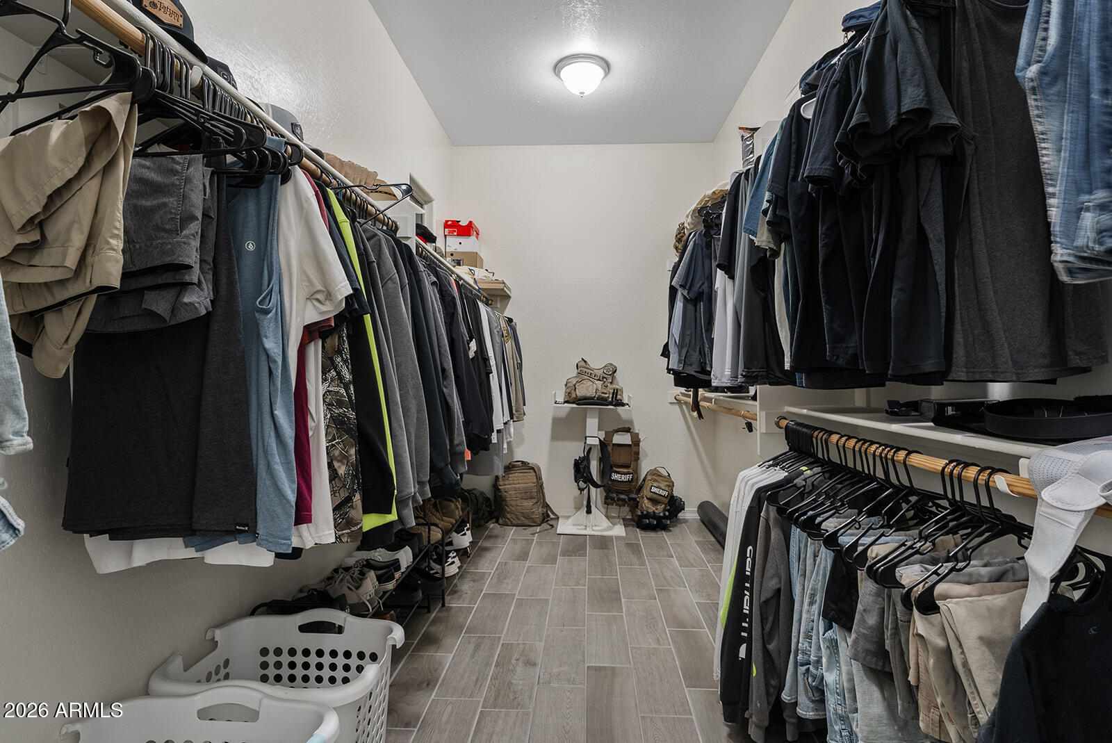 19411 East Timberline Road Queen Creek, AZ 85142 - Photo 33 of 44 a view of walk in closet with clothes and shoes