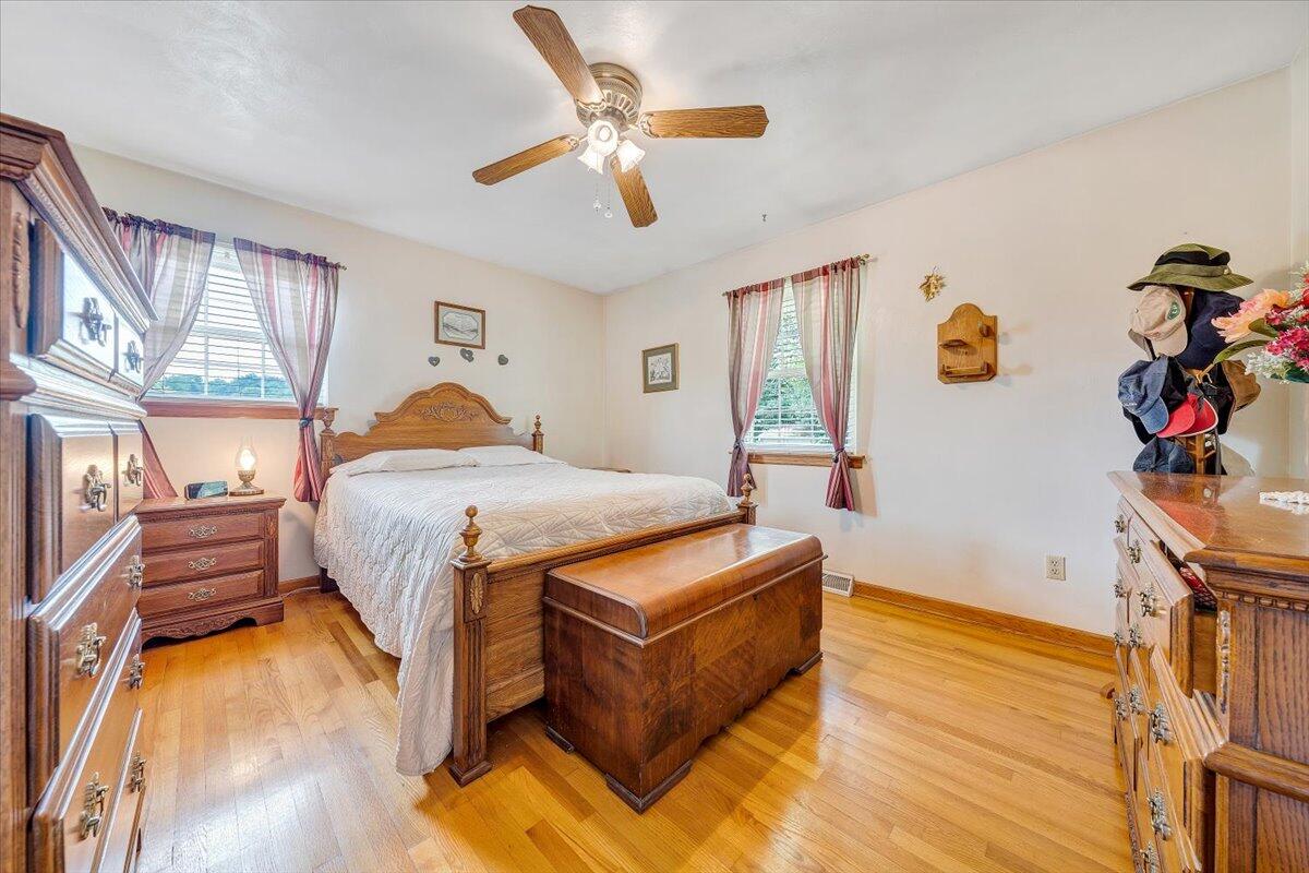 501 Olney Road Vinton, VA 24179 - Photo 19 of 49 a bedroom with a bed and wooden floor