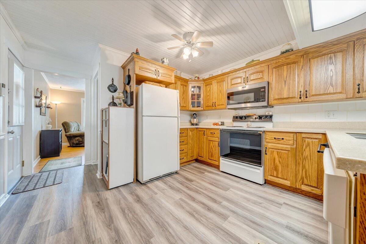 501 Olney Road Vinton, VA 24179 - Photo 8 of 49 a kitchen with stainless steel appliances granite countertop a refrigerator a stove top oven a sink dishwasher and white cabinets with wooden floor