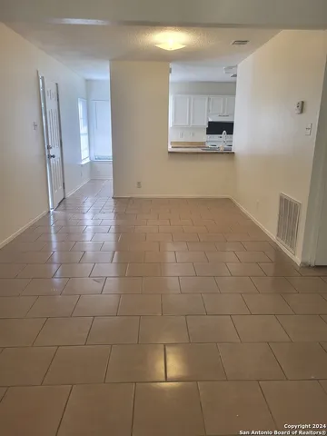 a view of a kitchen with a sink and a stove top oven