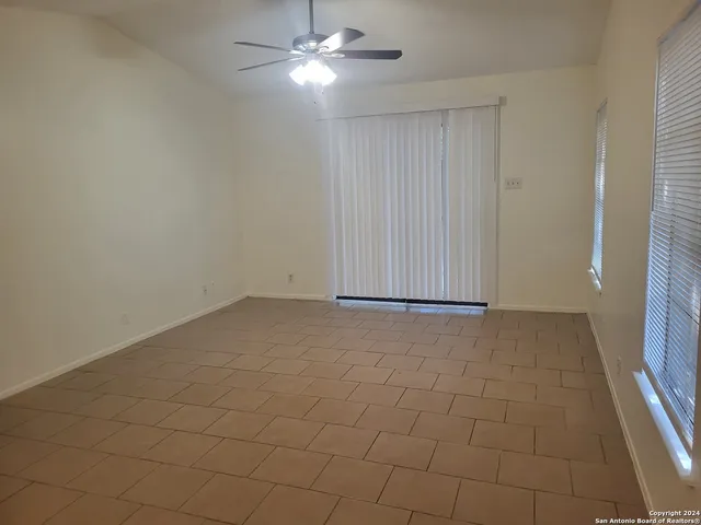 an empty room with closet and fan