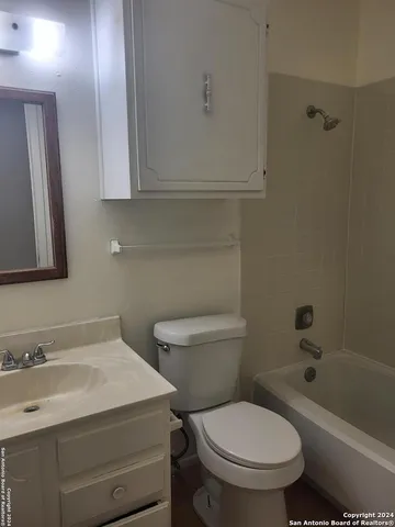 a bathroom with a sink a toilet and bathtub