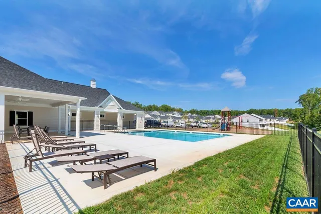 a view of a patio with dining table and chairs with wooden floor and fence