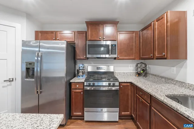 a kitchen with a stove and a refrigerator