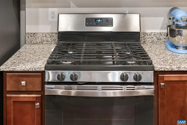 a stove top oven sitting inside of a kitchen