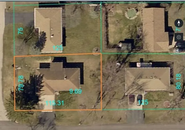 aerial view of a house with a yard