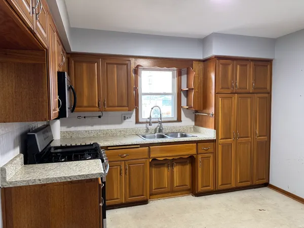 a kitchen with a sink a stove and refrigerator