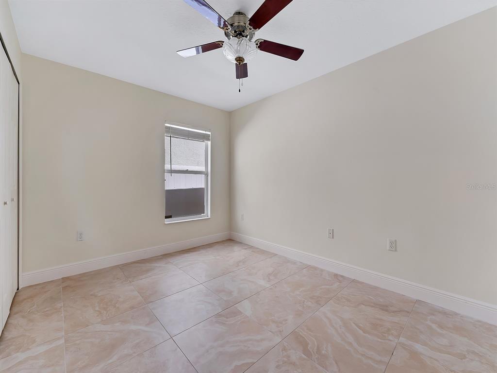 2111 Corner Point Court Orlando, FL 32820 - Photo 12 of 16 wooden floor in an empty room with a window