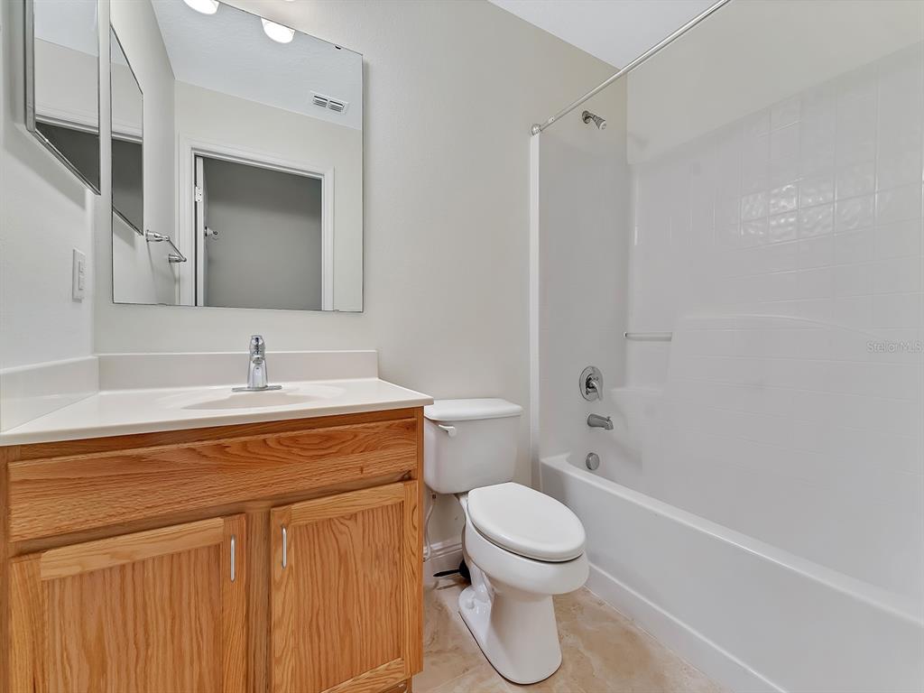 2111 Corner Point Court Orlando, FL 32820 - Photo 14 of 16 a bathroom with a sink a toilet and shower