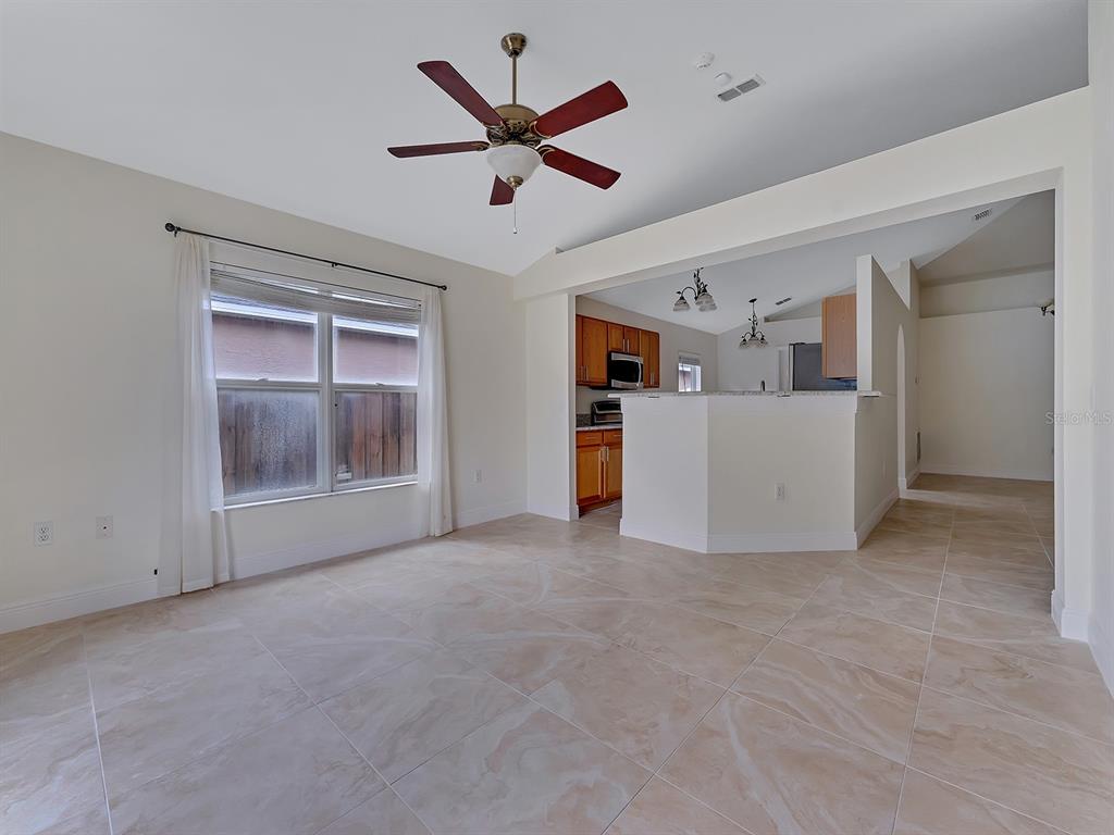 2111 Corner Point Court Orlando, FL 32820 - Photo 4 of 16 a view of work room with a ceiling fan and window
