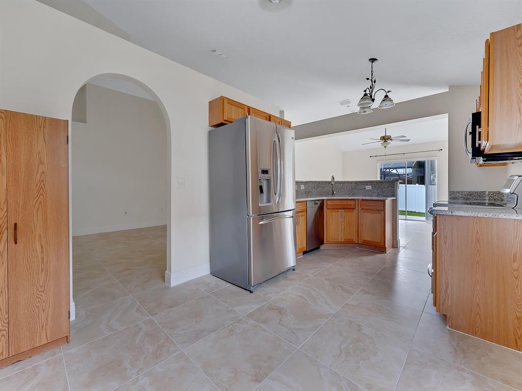 2111 Corner Point Court Orlando, FL 32820 - Photo 6 of 16 a kitchen with stainless steel appliances granite countertop a refrigerator and a stove top oven