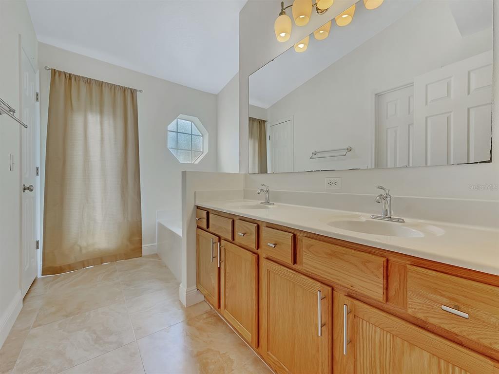 2111 Corner Point Court Orlando, FL 32820 - Photo 10 of 16 a bathroom with a sink and a mirror