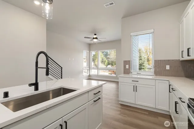 a kitchen with a sink cabinets and window