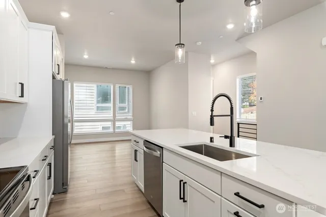 a kitchen with a sink a counter space and appliances