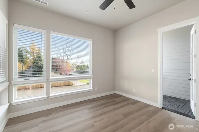 a view of a livingroom with wooden floor and a window