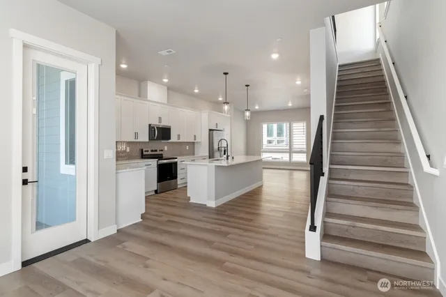 a view of kitchen with cabinets and wooden floor