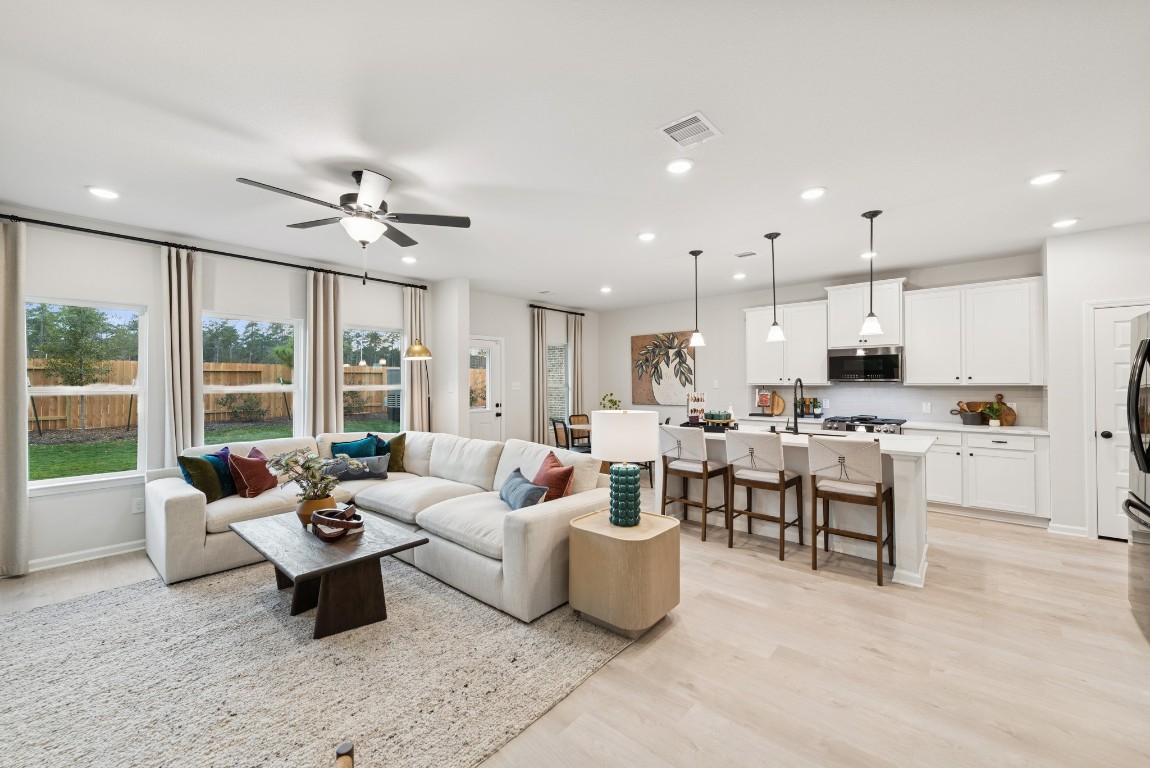 9726 Enclave Ridge Road Willis, TX 77318 - Photo 4 of 25 The Princeton II- Family Room and Kitchen. Staged model home shown for illustration only; actual features, colors, and upgrades may vary.