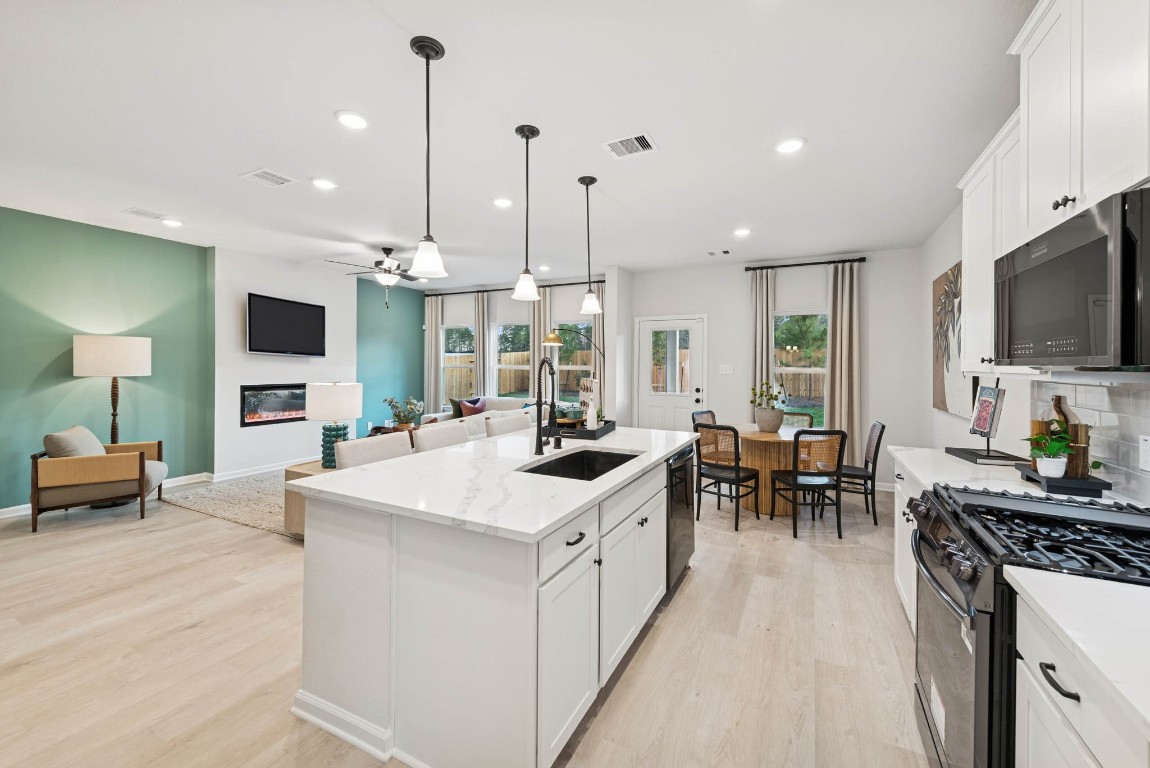 9726 Enclave Ridge Road Willis, TX 77318 - Photo 7 of 25 The Princeton II- Kitchen into the Family Room. Staged model home shown for illustration only; actual features, colors, and upgrades may vary.