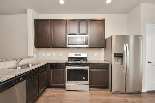 a kitchen with a stove and a refrigerator