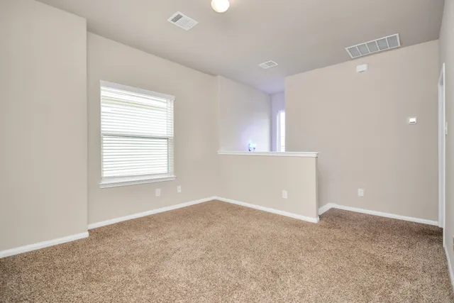 an empty room with windows and closet